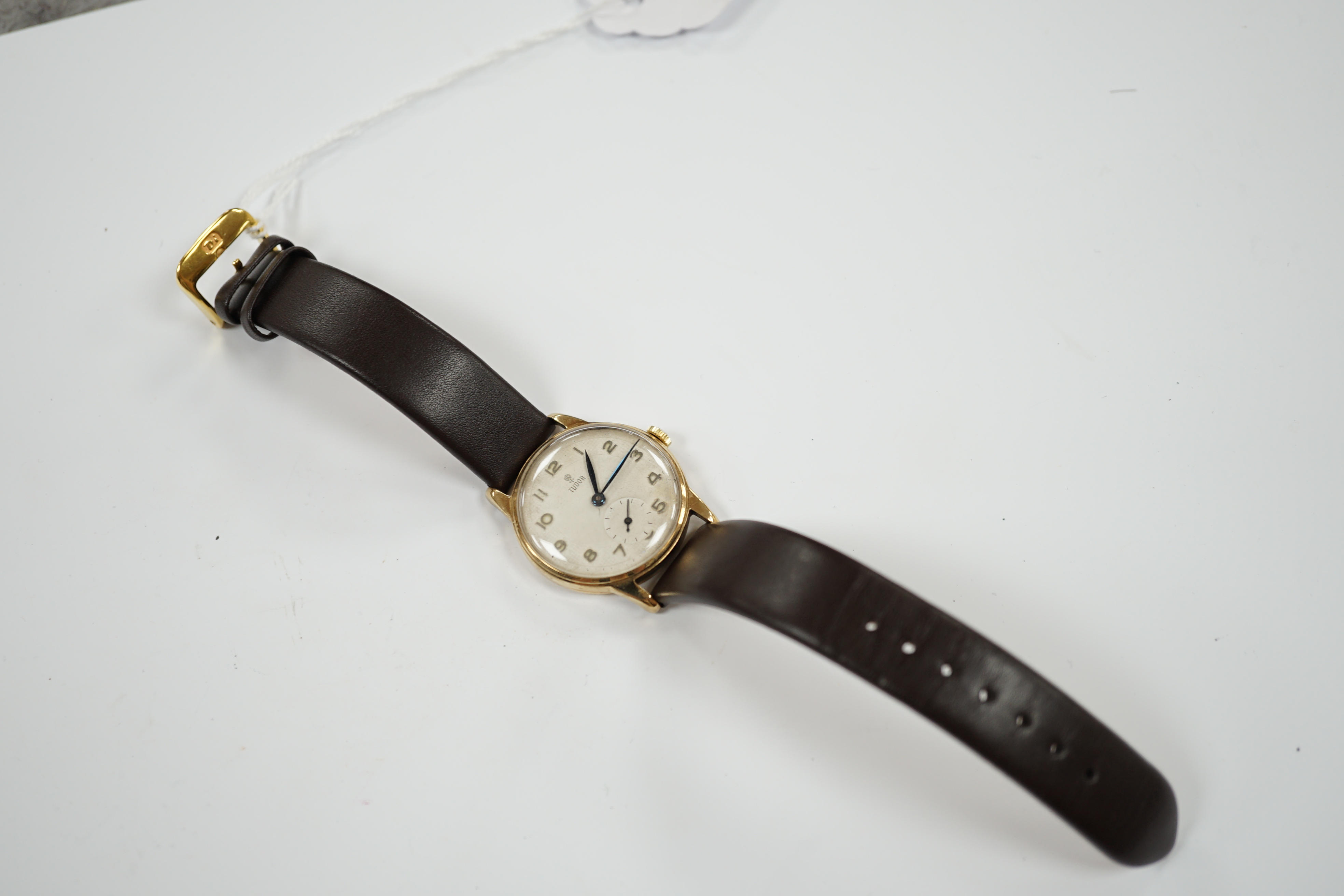 A gentleman's 9ct gold Tudor manual wind wrist watch, with Arabic dial and subsidiary seconds, on later associated strap, case diameter 31mm.